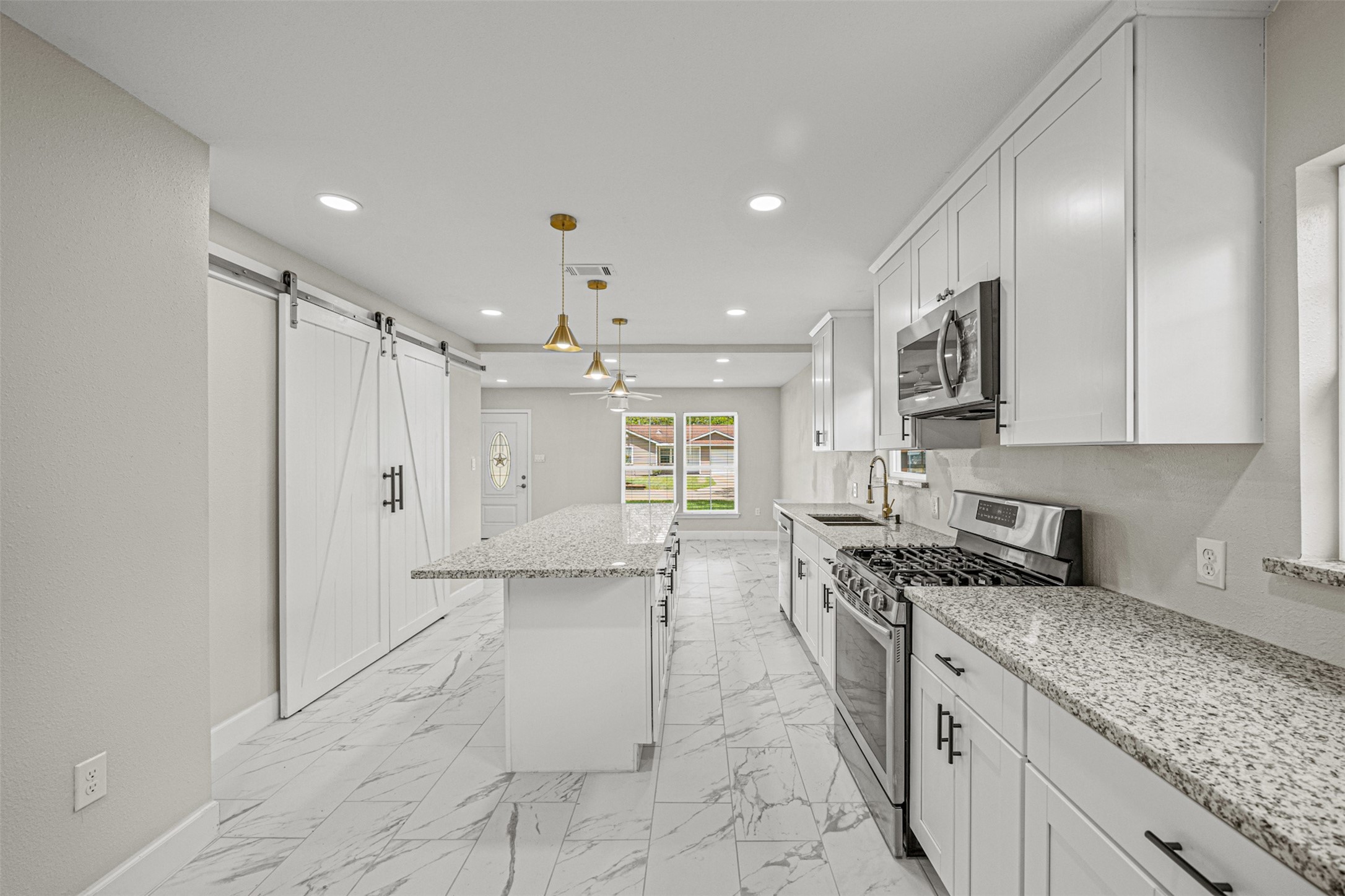 702 Norell Street Channelview, TX 77530 - Photo 5 of 16 a kitchen with stainless steel appliances granite countertop a sink stove and cabinets