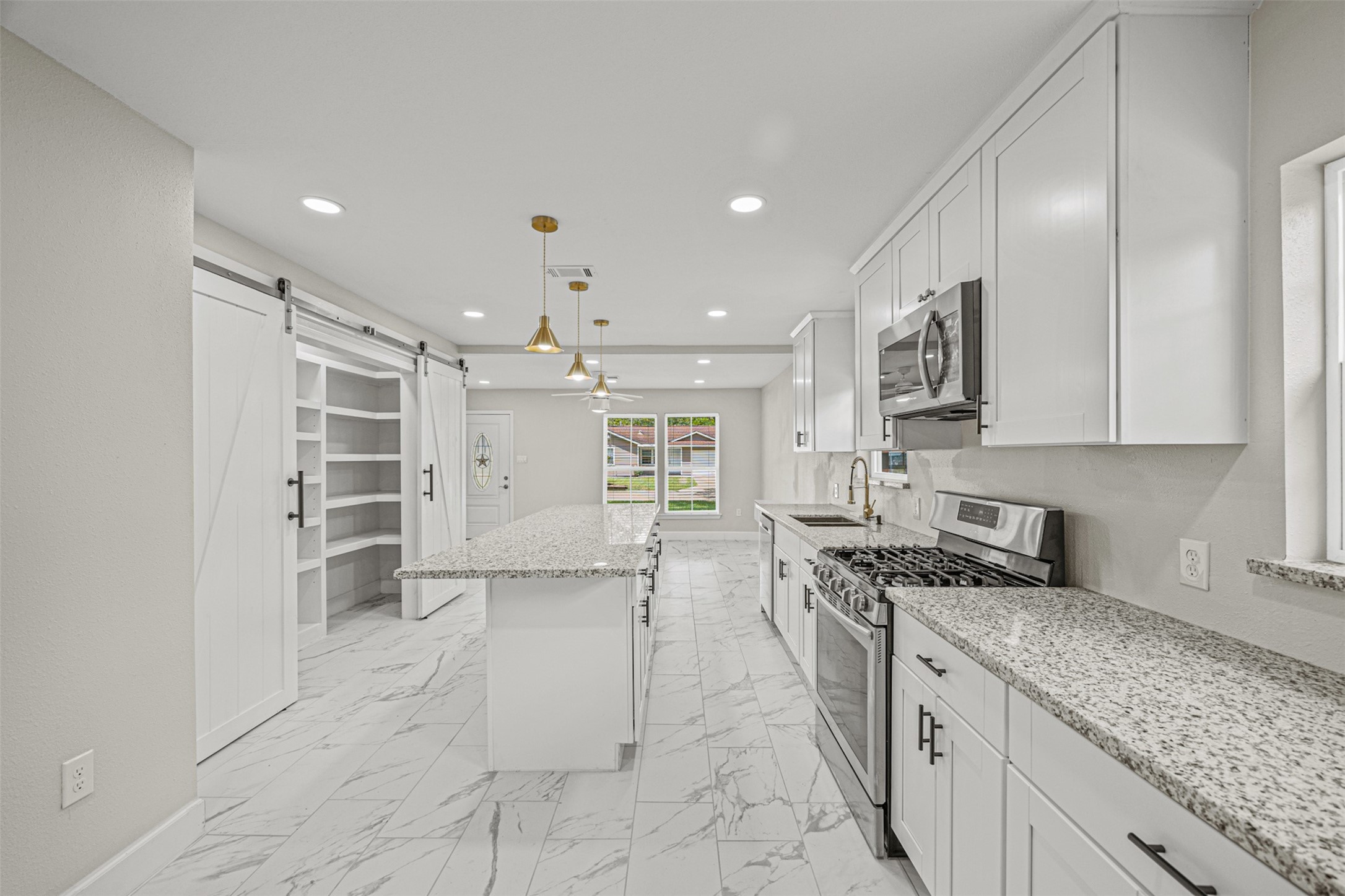 702 Norell Street Channelview, TX 77530 - Photo 6 of 16 a kitchen with stainless steel appliances granite countertop a sink stove and cabinets