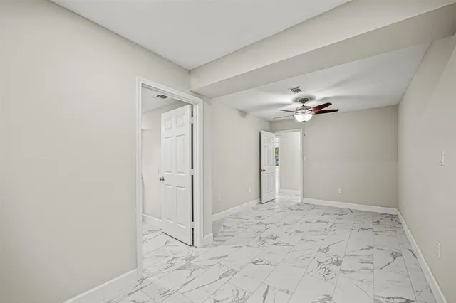 a view of a bathroom with a shower and a chandelier