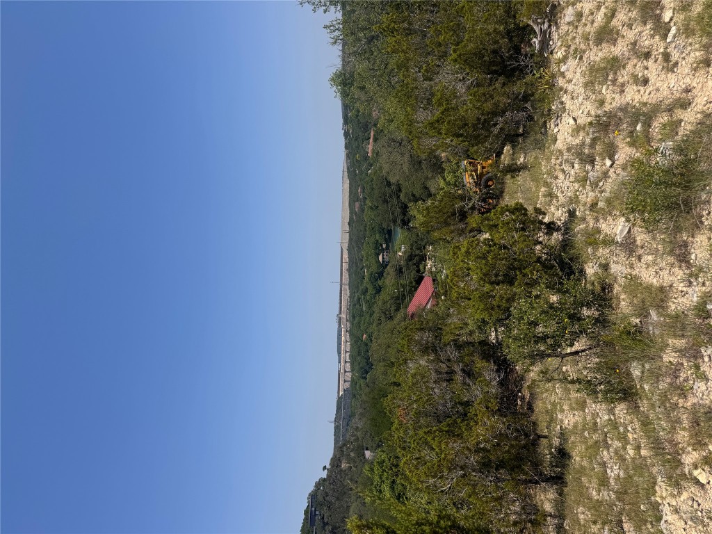 2506 Geronimo Trail Austin, TX 78734 - Photo 2 of 22 a view of a lake with mountains in the background