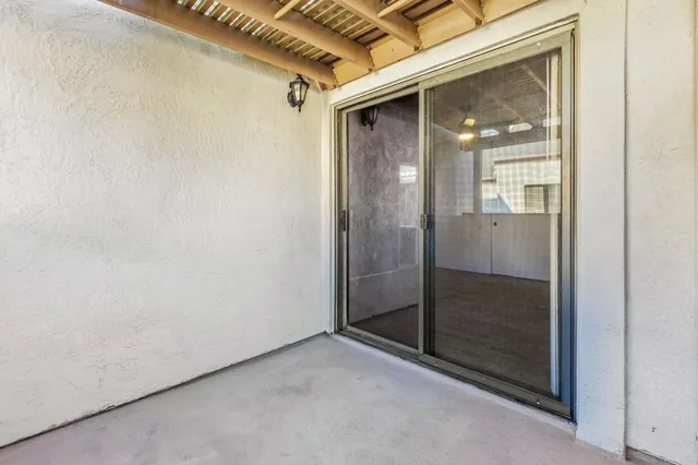 a bathroom with a granite countertop sink a toilet and a mirror