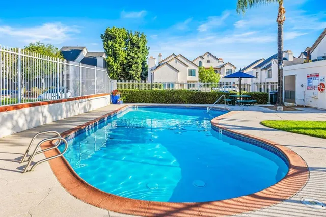 a view of a house with swimming pool and porch