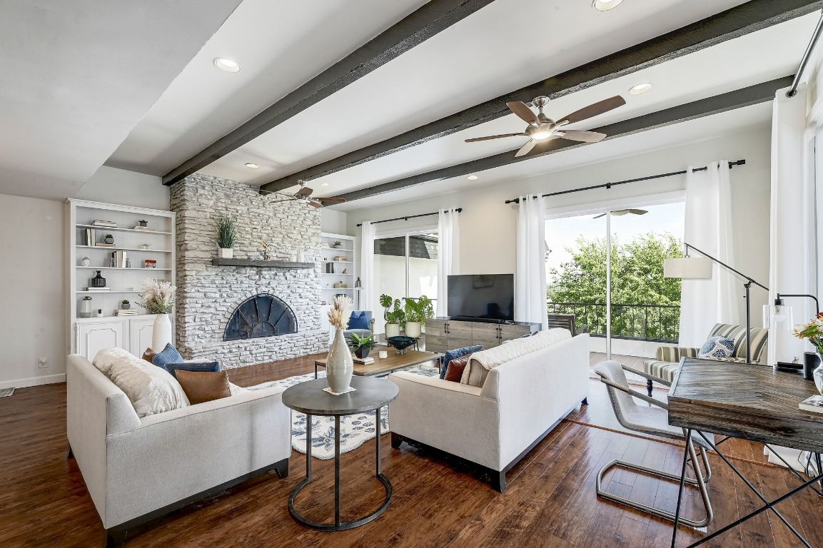 a living room with furniture a fireplace and a table