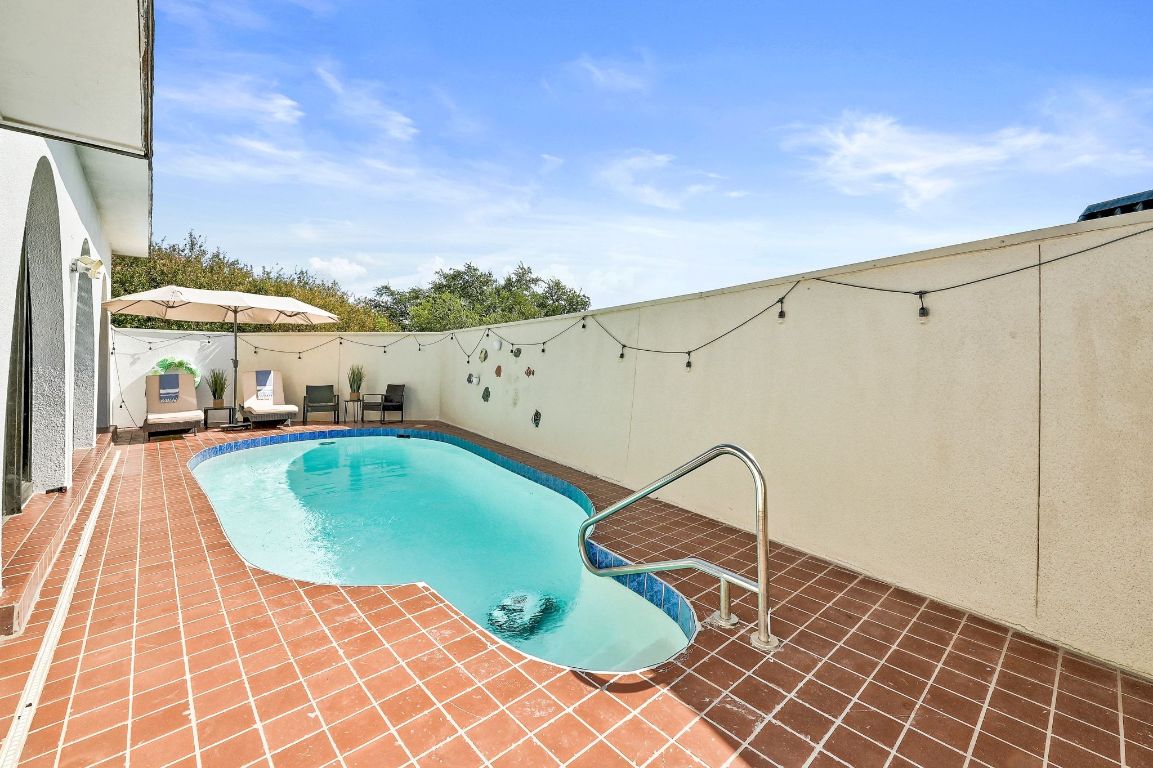 409 Seawind Lakeway, TX 78734 - Photo 11 of 18 a view of a swimming pool with a terrace