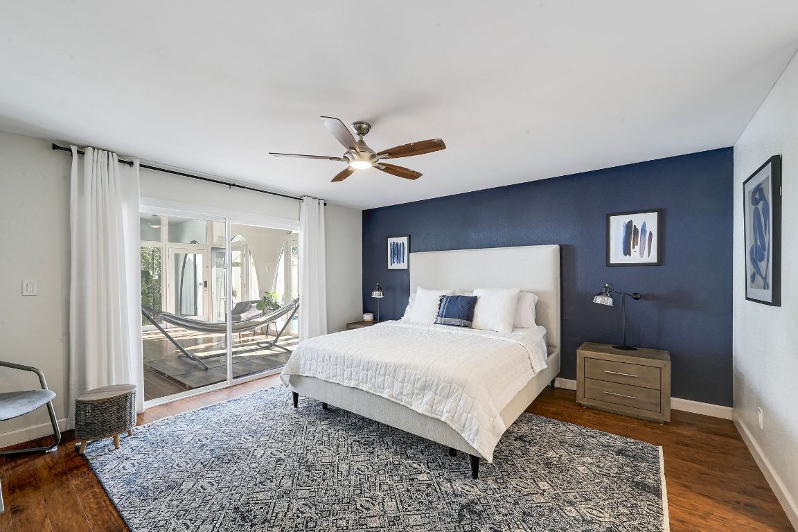 409 Seawind Lakeway, TX 78734 - Photo 12 of 18 a bedroom with a large bed and a chandelier