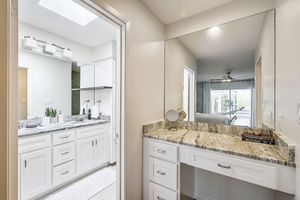 409 Seawind Lakeway, TX 78734 - Photo 14 of 18 a bathroom with a granite countertop sink mirror and double