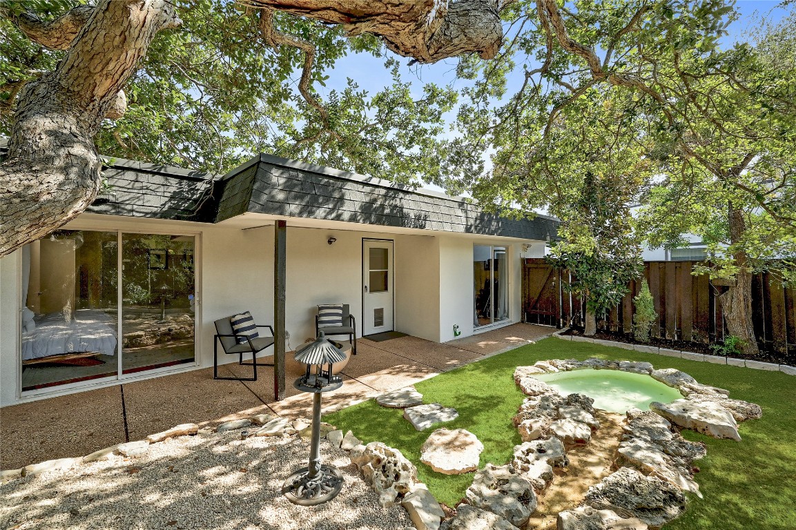 409 Seawind Lakeway, TX 78734 - Photo 17 of 18 a front view of a house with a yard and seating space