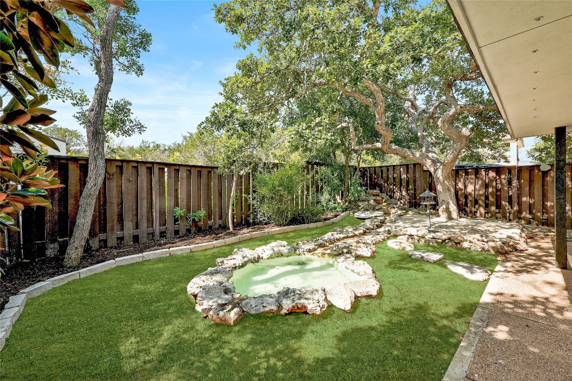 409 Seawind Lakeway, TX 78734 - Photo 18 of 18 a backyard of a house with table and chairs