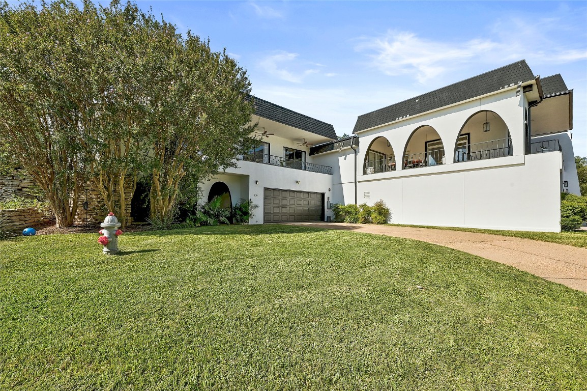 409 Seawind Lakeway, TX 78734 - Photo 3 of 18 a front view of a house with a yard