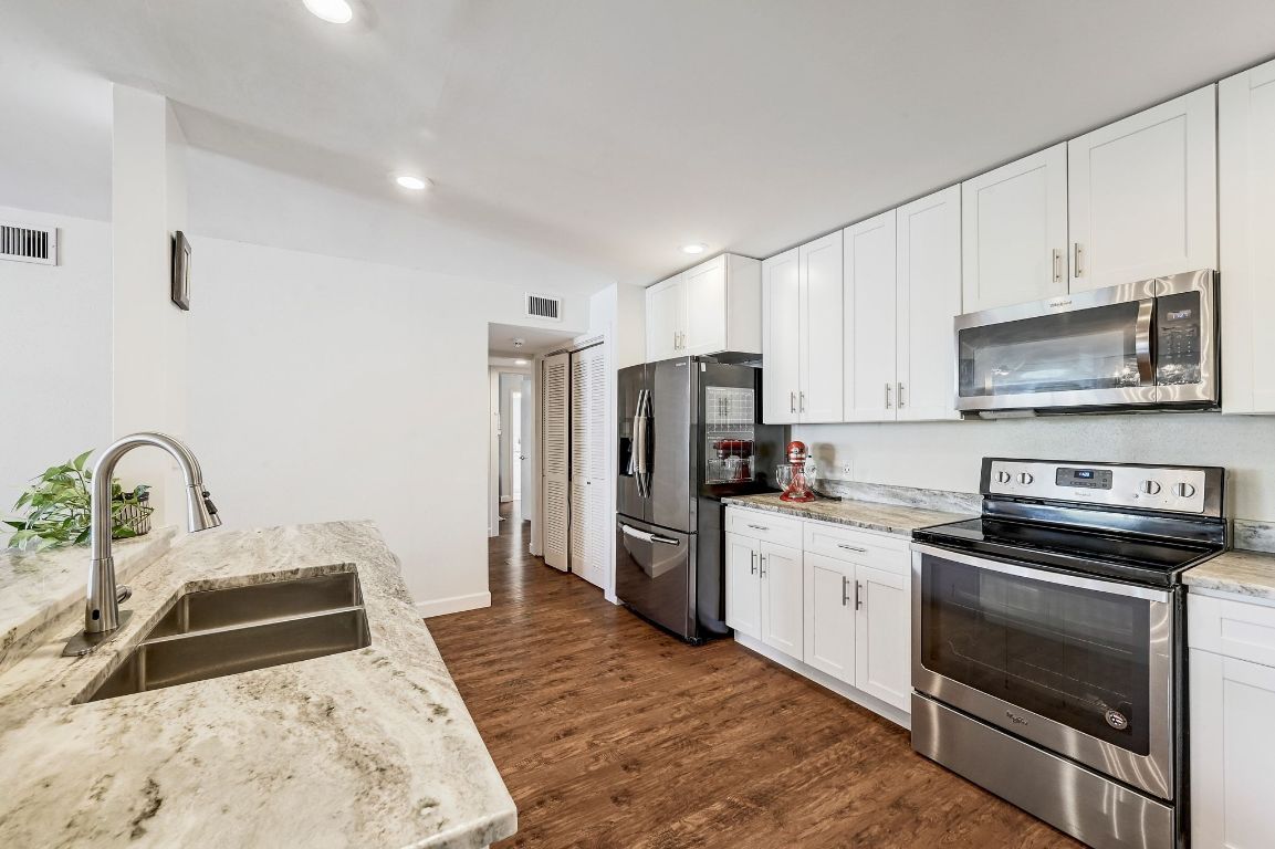 409 Seawind Lakeway, TX 78734 - Photo 7 of 18 a kitchen with a refrigerator stove and sink