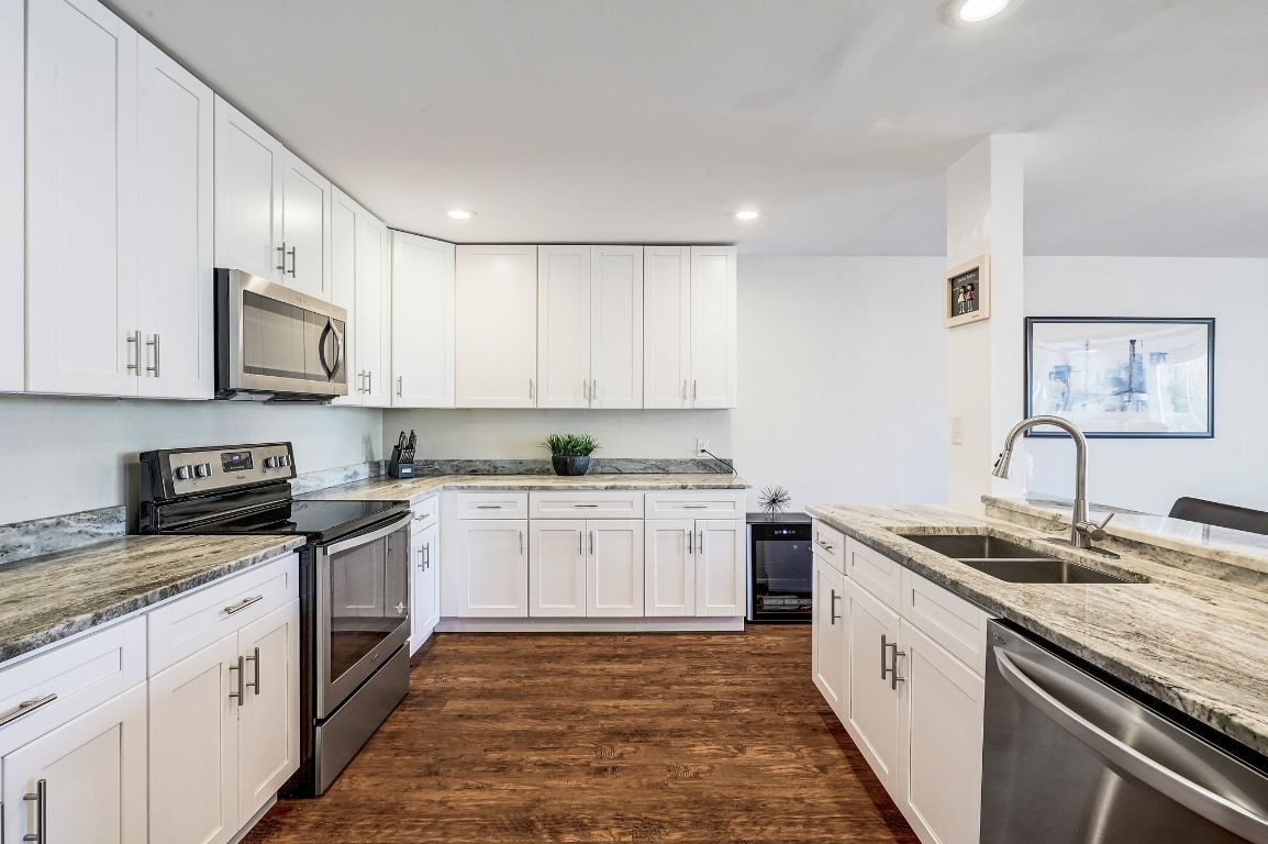 409 Seawind Lakeway, TX 78734 - Photo 9 of 18 a kitchen with granite countertop a sink and cabinets