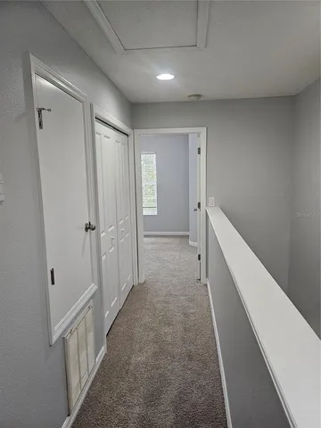 a view of an empty room and closet area