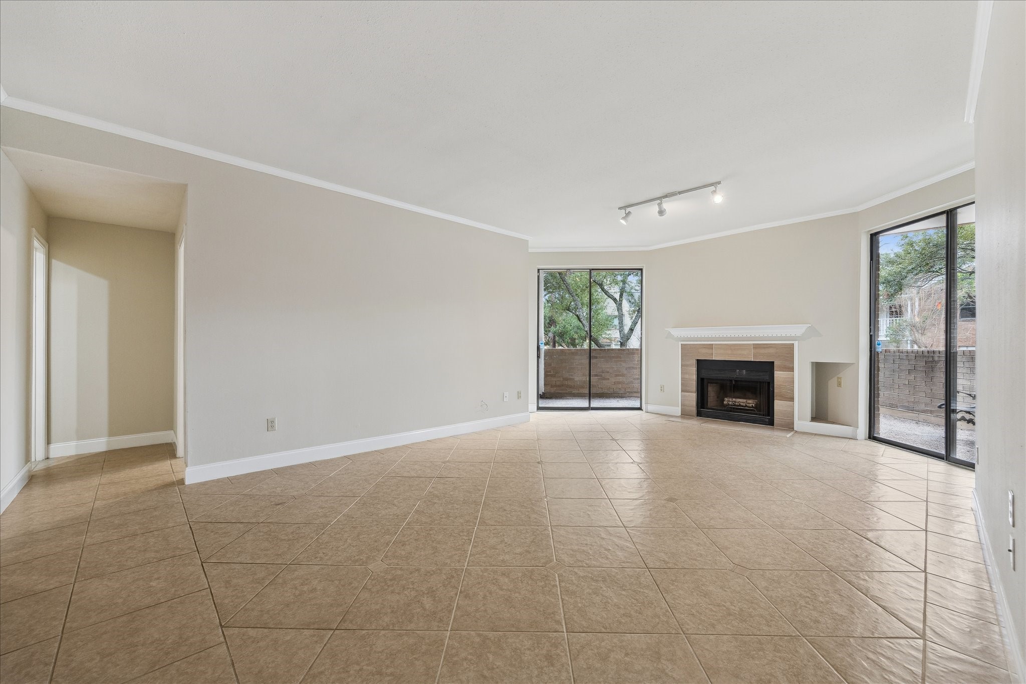 5220 Weslayan Street, Unit 109 Houston, TX 77005 - Photo 11 of 21 Another view of the living room with wood burning fireplace. Doorway leads to the great bath ad secondary bedroom.