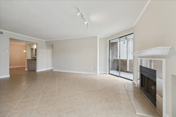 a view of a livingroom with an empty space and a fireplace