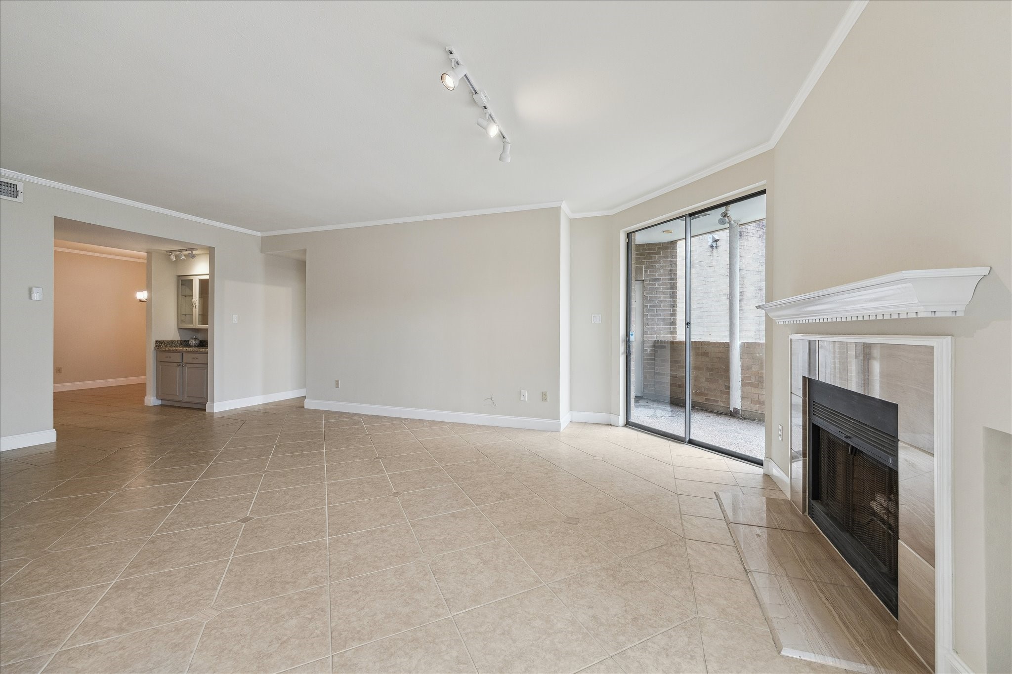 5220 Weslayan Street, Unit 109 Houston, TX 77005 - Photo 12 of 21 View of the living room looking back to the dry bar area, dining room and kitchen.