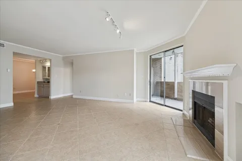 a view of a livingroom with an empty space and a fireplace