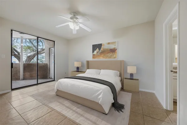 a bedroom with a bed and a painting on the wall