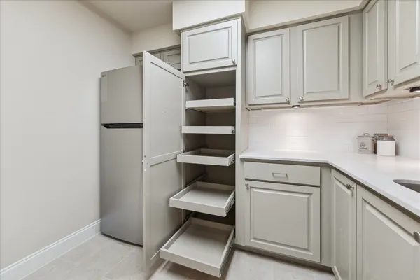 a kitchen with a refrigerator and cabinets