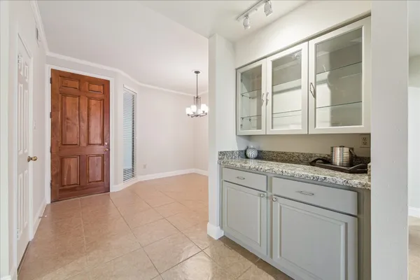 a spacious bathroom with a granite countertop sink and a mirror