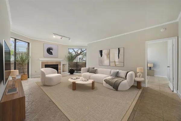 a living room with furniture fireplace and large window