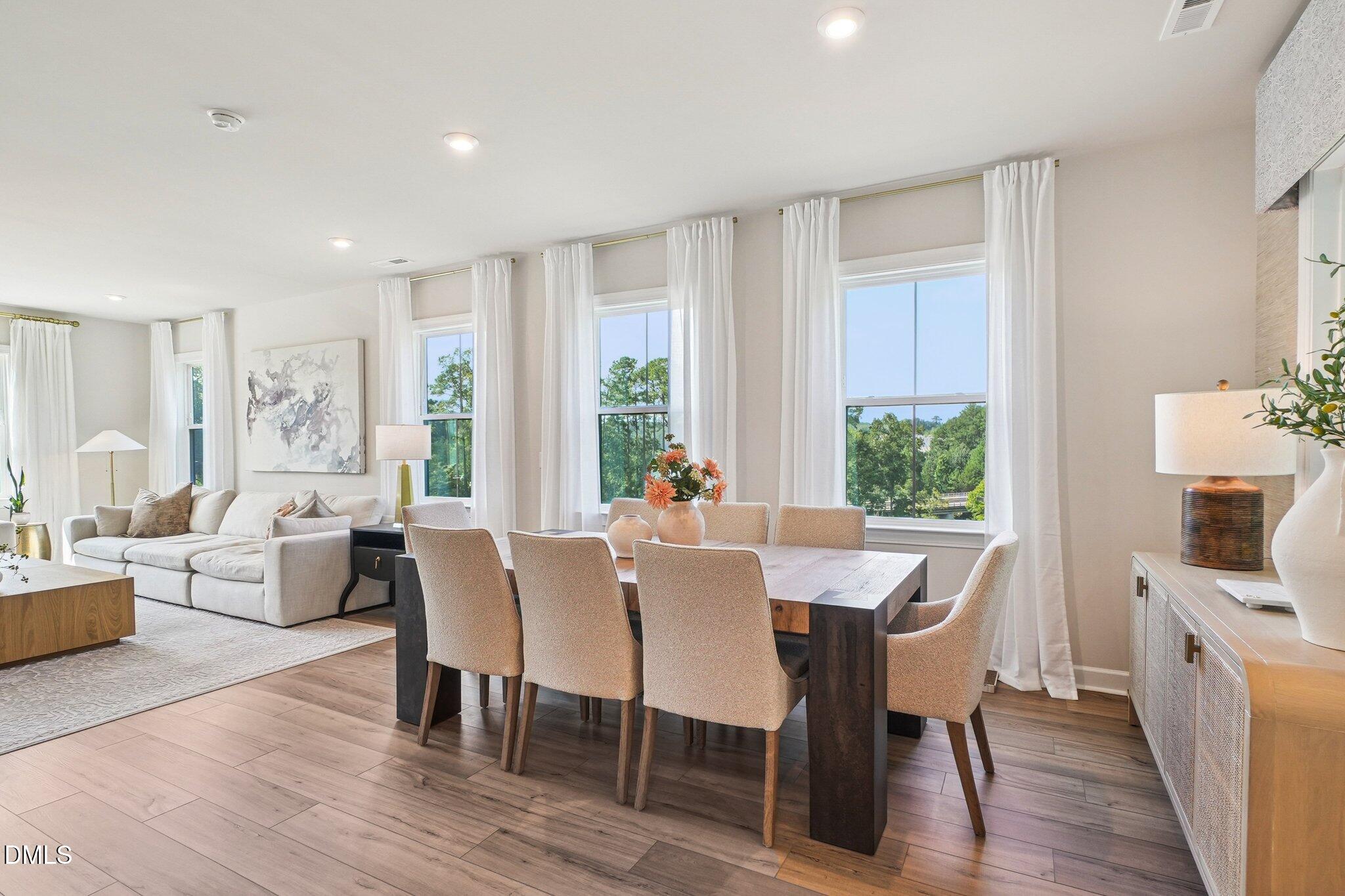 4822 Cypress Tree Lane Raleigh, NC 27612 - Photo 8 of 28 a view of a dining room with furniture window and wooden floor