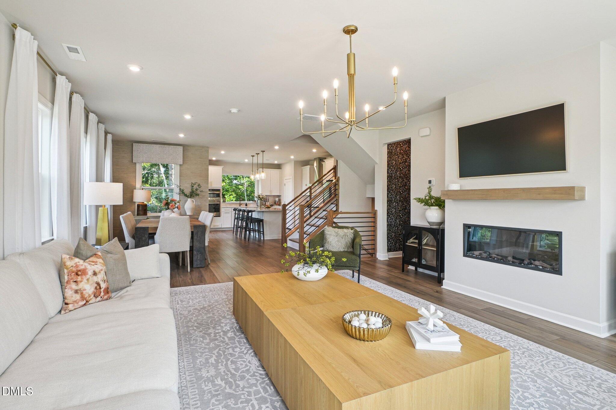 4822 Cypress Tree Lane Raleigh, NC 27612 - Photo 6 of 28 a living room with furniture a flat screen tv and a fireplace