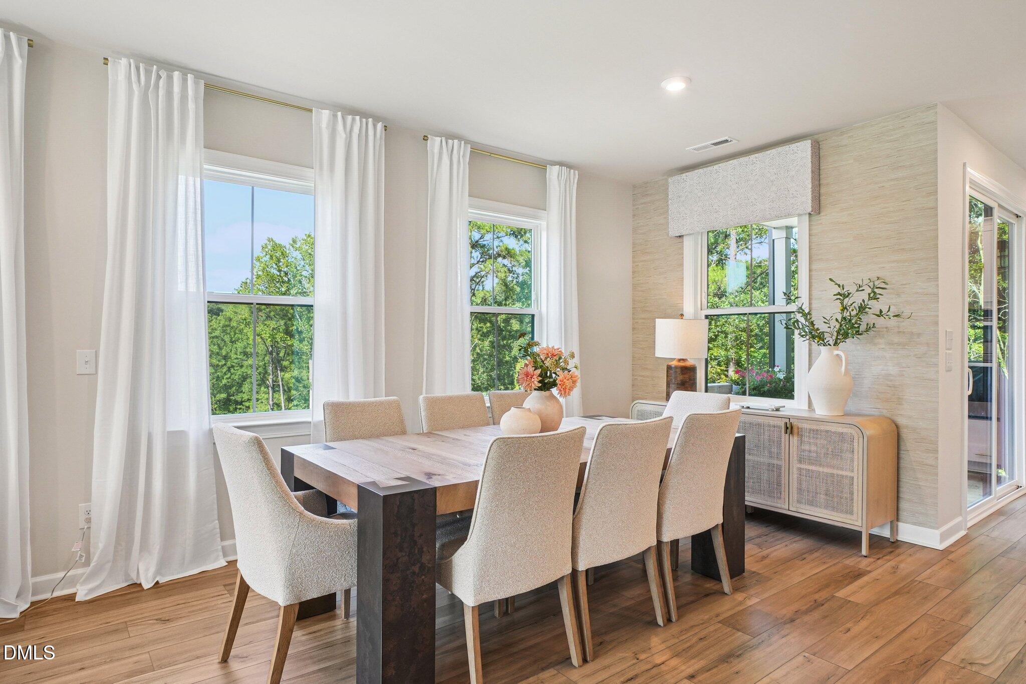 4822 Cypress Tree Lane Raleigh, NC 27612 - Photo 7 of 28 a view of a dining room with furniture window and wooden floor