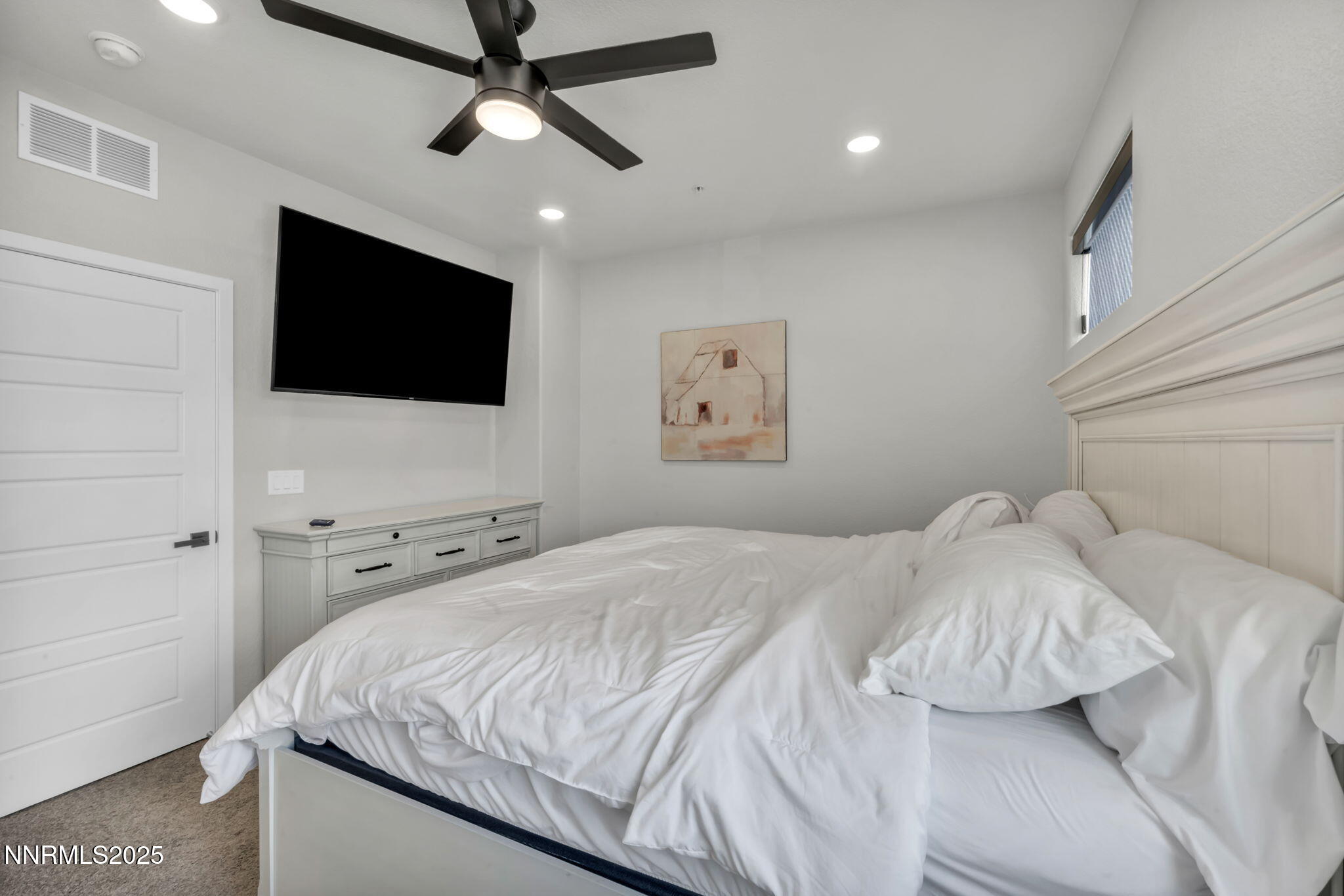 150 Rissone Lane Reno, NV 89503 - Photo 26 of 53 a bedroom with a bed and a flat screen tv