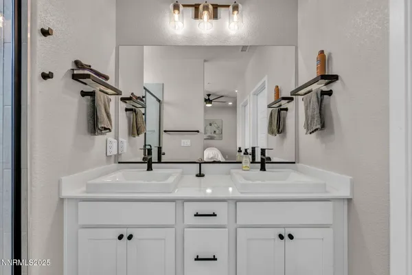 a bathroom with a sink and mirror