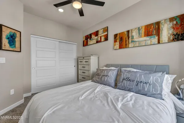 a bedroom with a bed and a painting on the wall