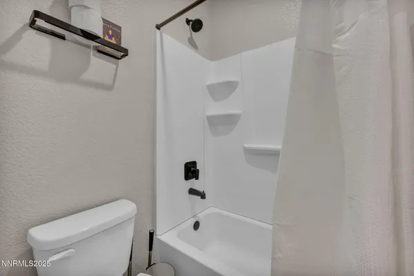 a bathroom with a toilet and a bathtub
