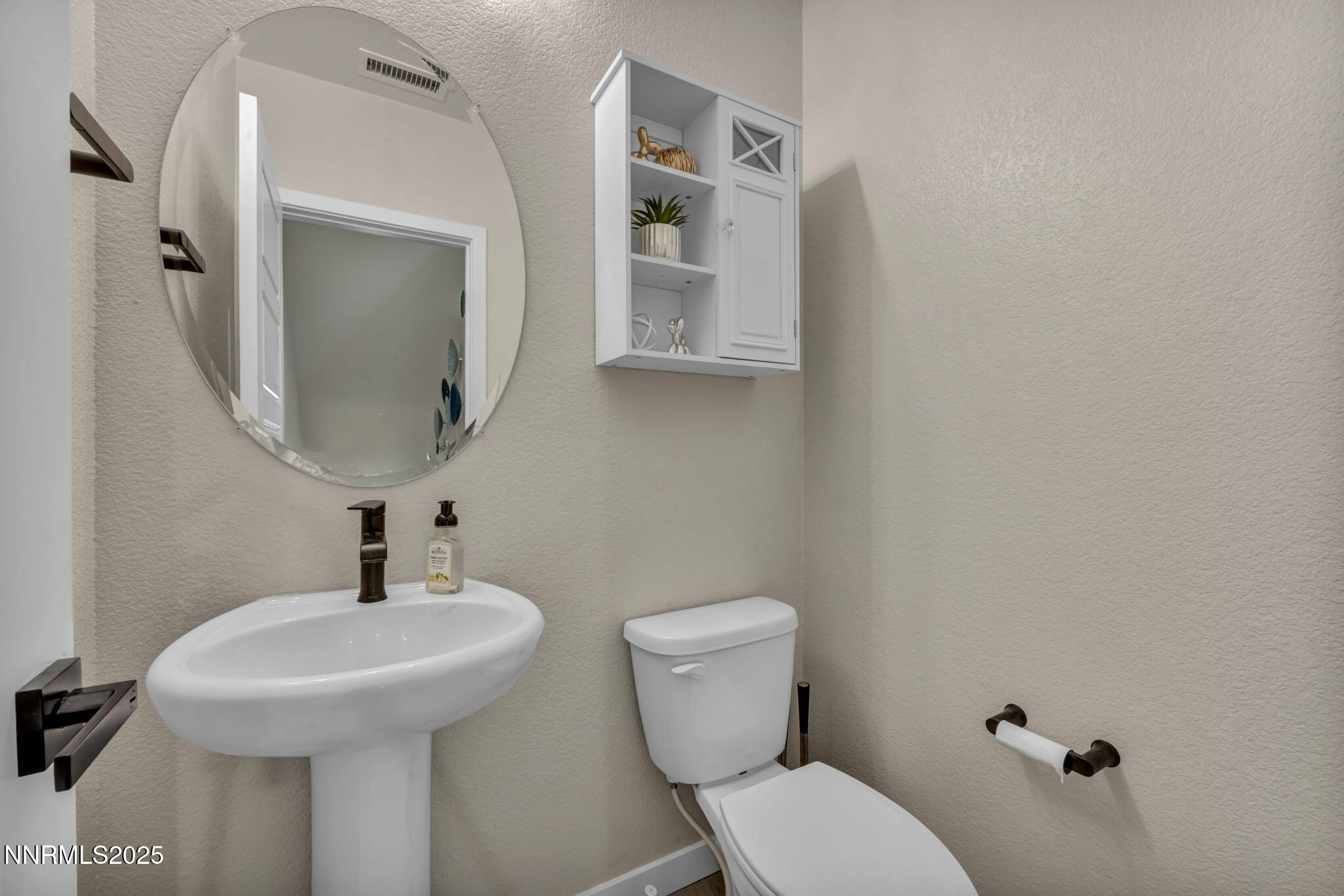 150 Rissone Lane Reno, NV 89503 - Photo 36 of 53 a bathroom with a toilet sink and mirror