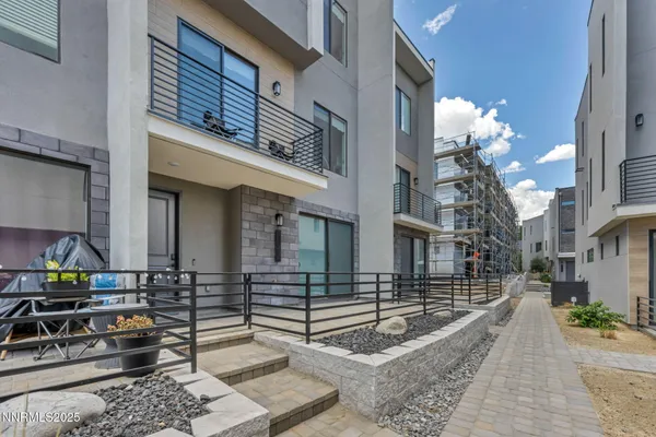 a view of a balcony with furniture and wooden floor
