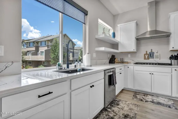a kitchen with stainless steel appliances granite countertop a sink stove and cabinets