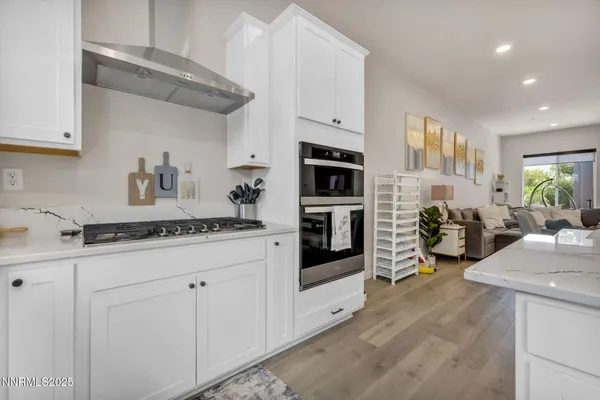 a kitchen with stainless steel appliances a sink stove and cabinets