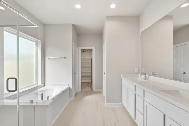 a bathroom with a bathtub and a shower