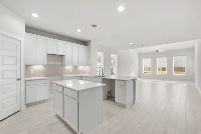 a kitchen with a sink stove and cabinets