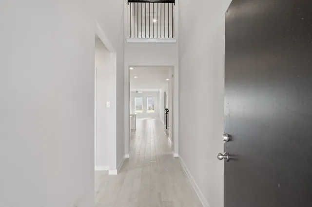 a view of a room with wooden floor and a bathroom