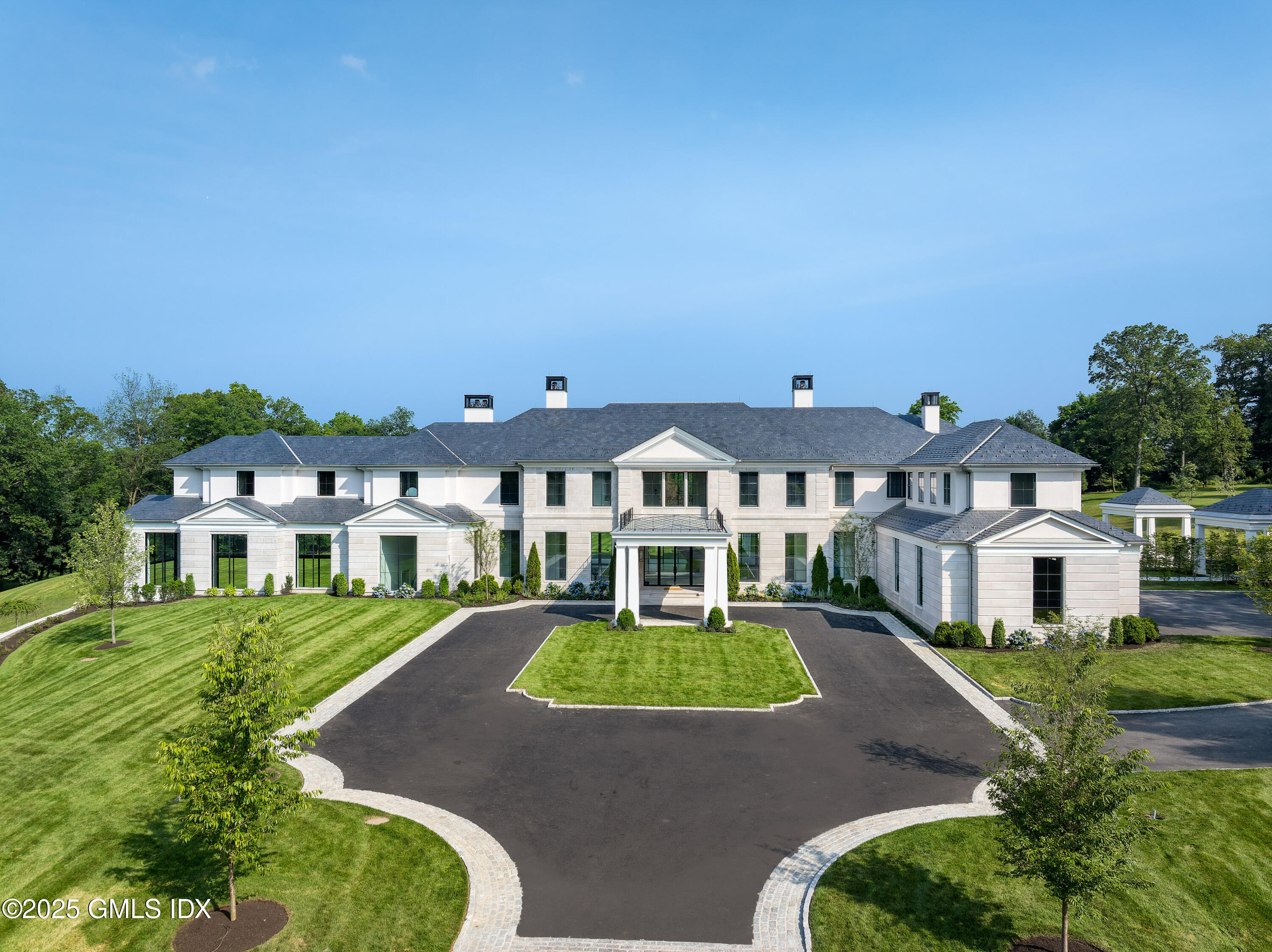 a view of a white house with a yard