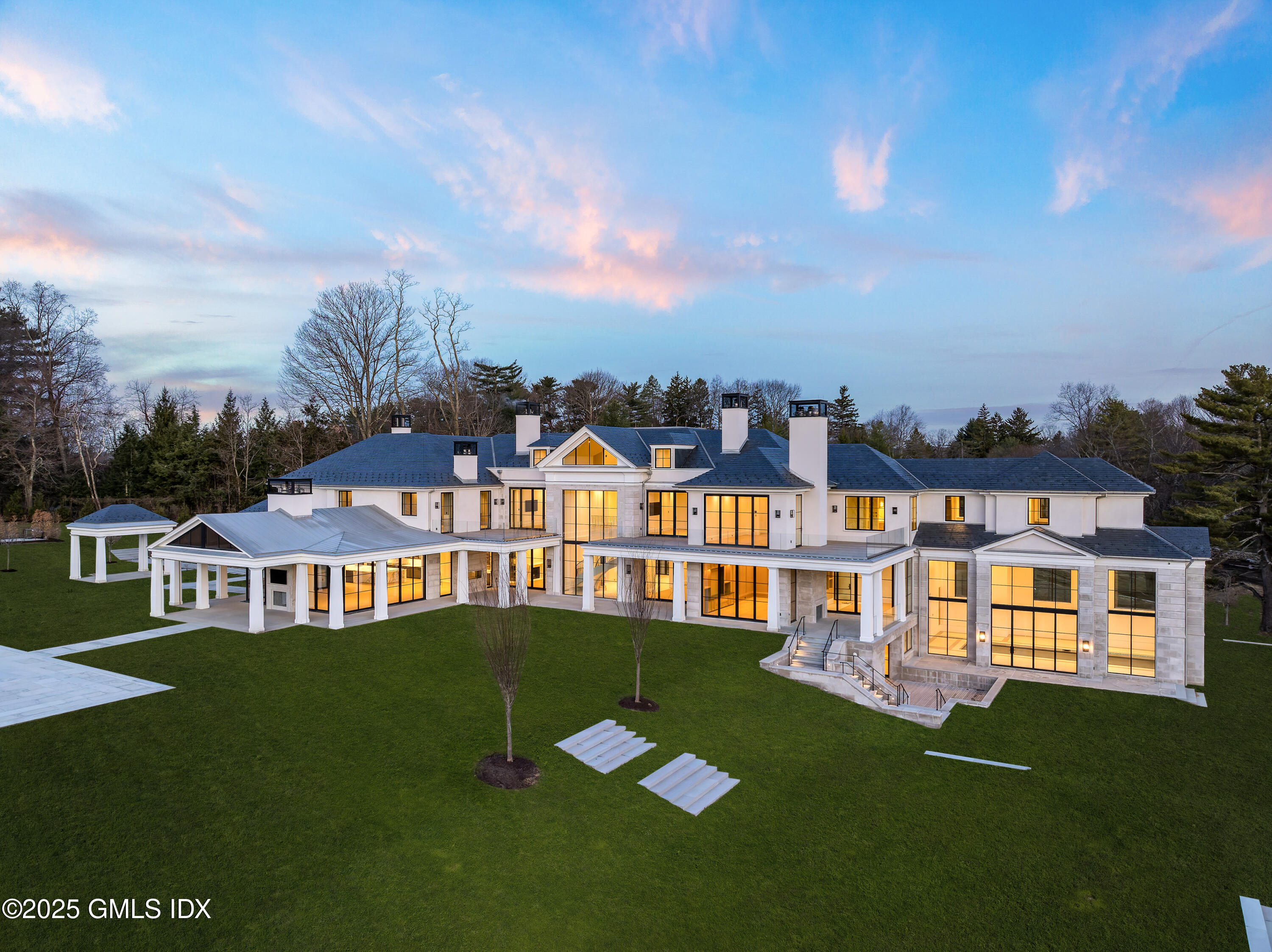 214 Clapboard Ridge Road Greenwich, CT 06831 - Photo 3 of 7 a view of a white house with a big yard and potted plants