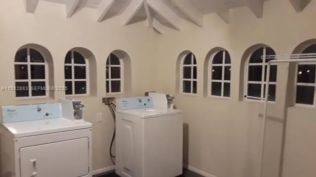 a view of a sink storage and utility room with washer and dryer