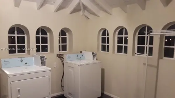 a view of a sink storage and utility room with washer and dryer