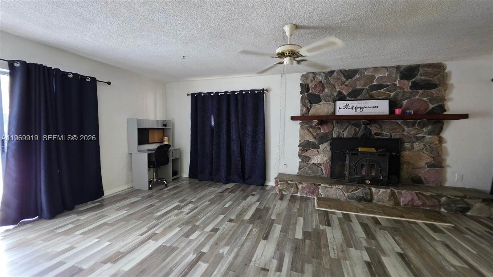18227 Branch Road Hudson, FL 34667 - Photo 3 of 17 a view of a livingroom with a fireplace and cabinets