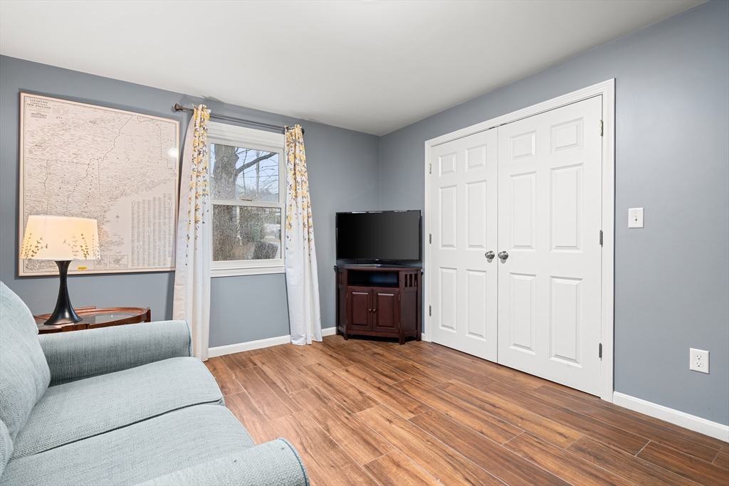 51 Winslow Road Reading, MA 01867 - Photo 17 of 40 a living room with furniture and a flat screen tv