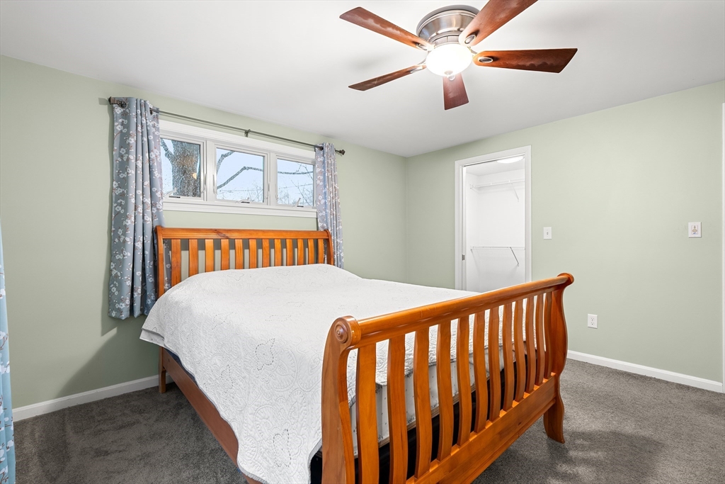 51 Winslow Road Reading, MA 01867 - Photo 19 of 40 a bedroom with a bed and a chandelier