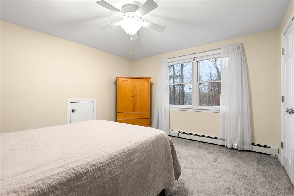 51 Winslow Road Reading, MA 01867 - Photo 22 of 40 a bedroom with a large bed and a window