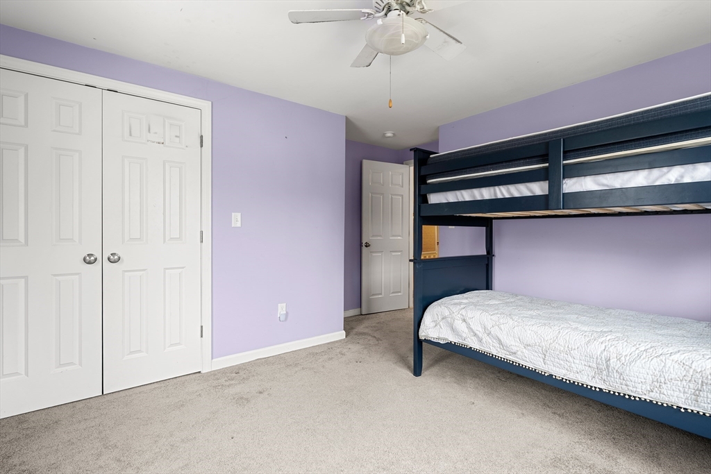 51 Winslow Road Reading, MA 01867 - Photo 25 of 40 a bedroom with a bed and a chandelier
