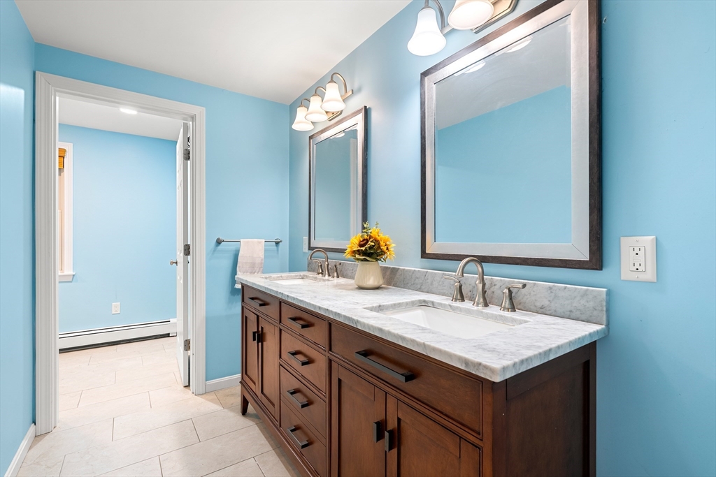 51 Winslow Road Reading, MA 01867 - Photo 26 of 40 a bathroom with a sink and a mirror