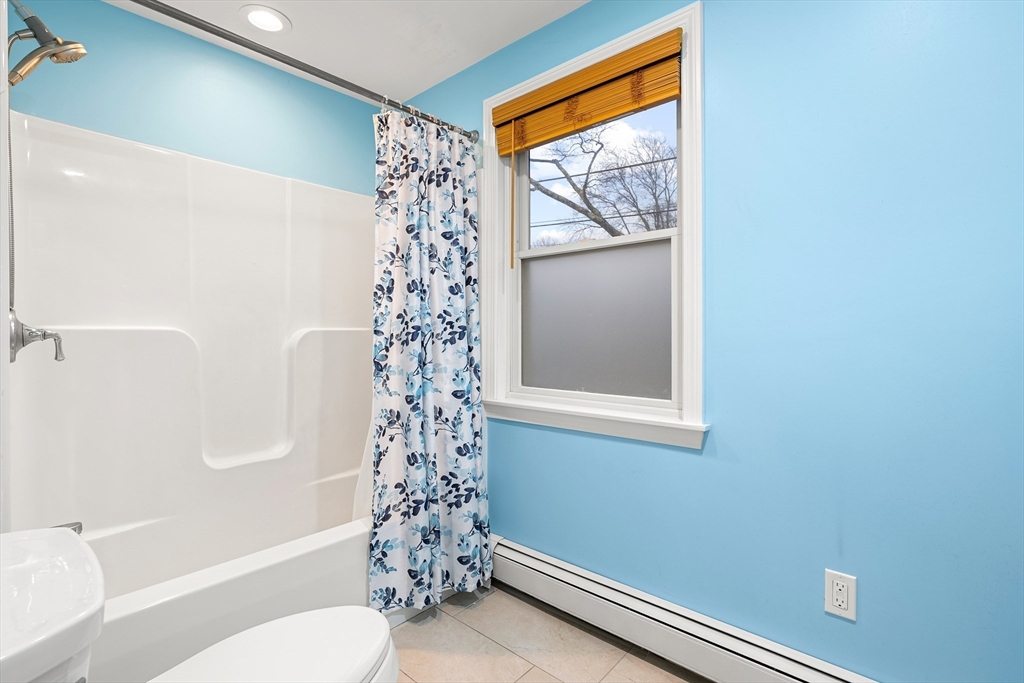 51 Winslow Road Reading, MA 01867 - Photo 27 of 40 a bathroom with a toilet a sink and a shower
