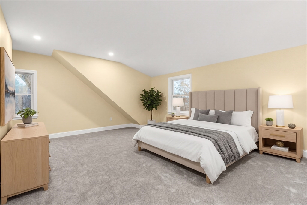 51 Winslow Road Reading, MA 01867 - Photo 28 of 40 a spacious bedroom with a bed and a potted plant